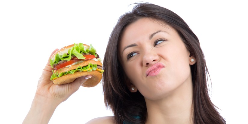 Person holding a burger in hand