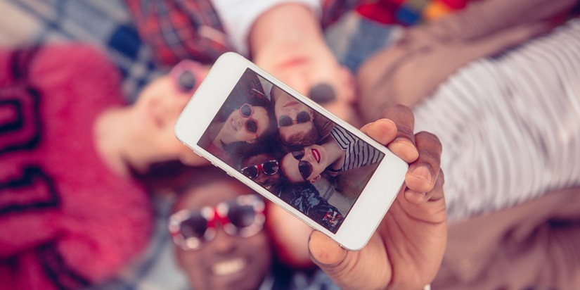 teens taking a photo with a cell phone