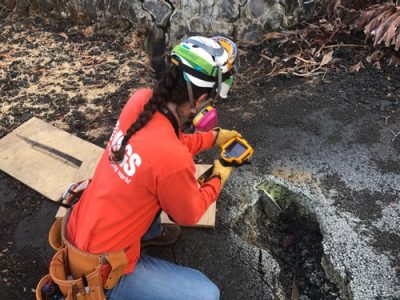 A geologist using a thermal camera in the field