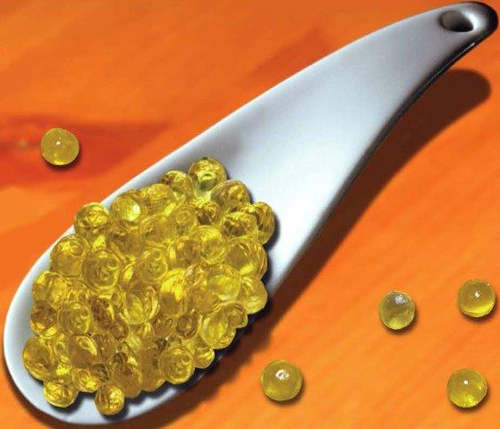 A spoon holding olive oil “caviar”