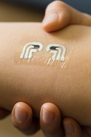 An ultra-thin sensor on a person's arm